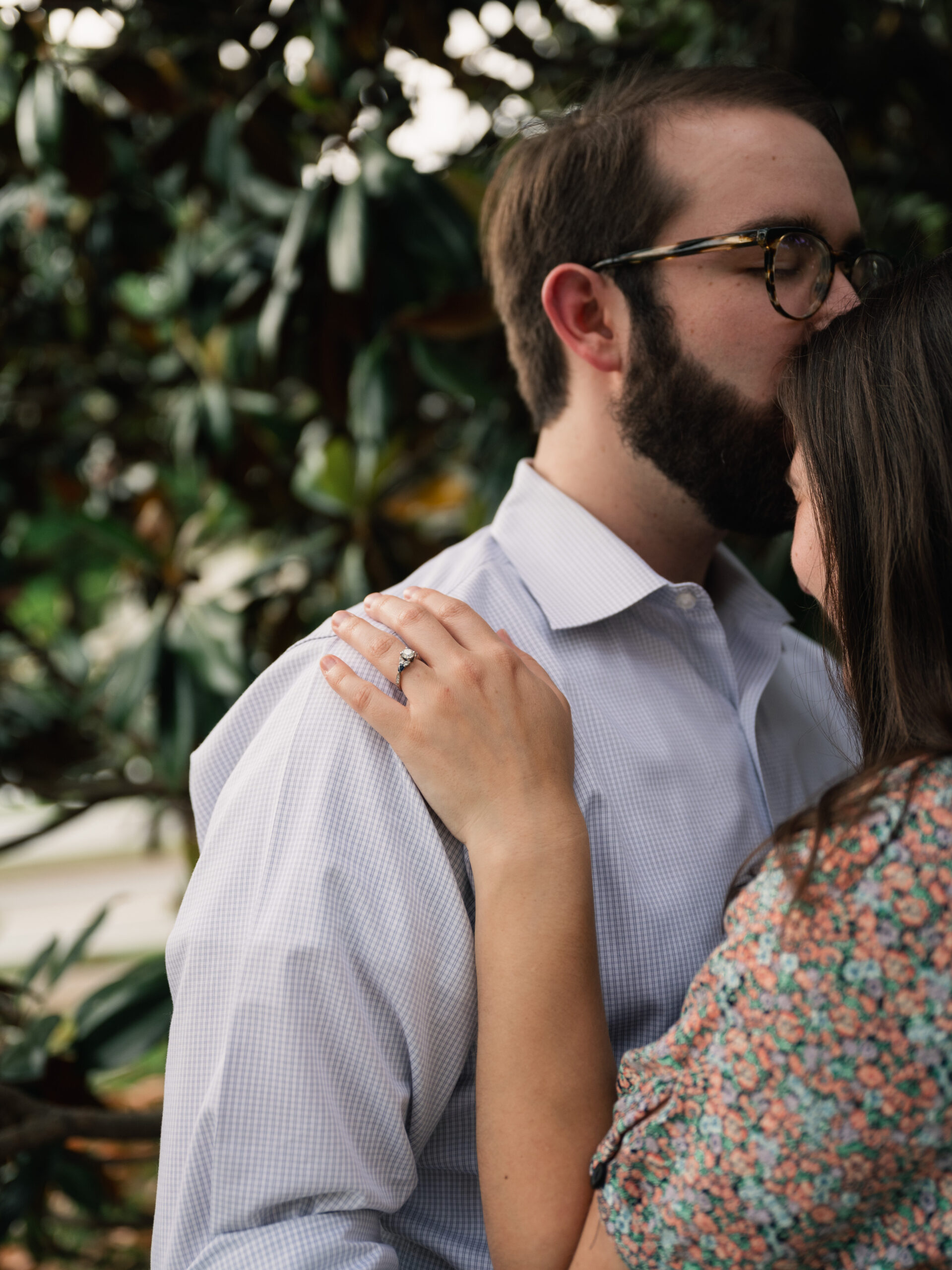 A couple wears light blue check and a floral print for their mid-summer engagement photos.