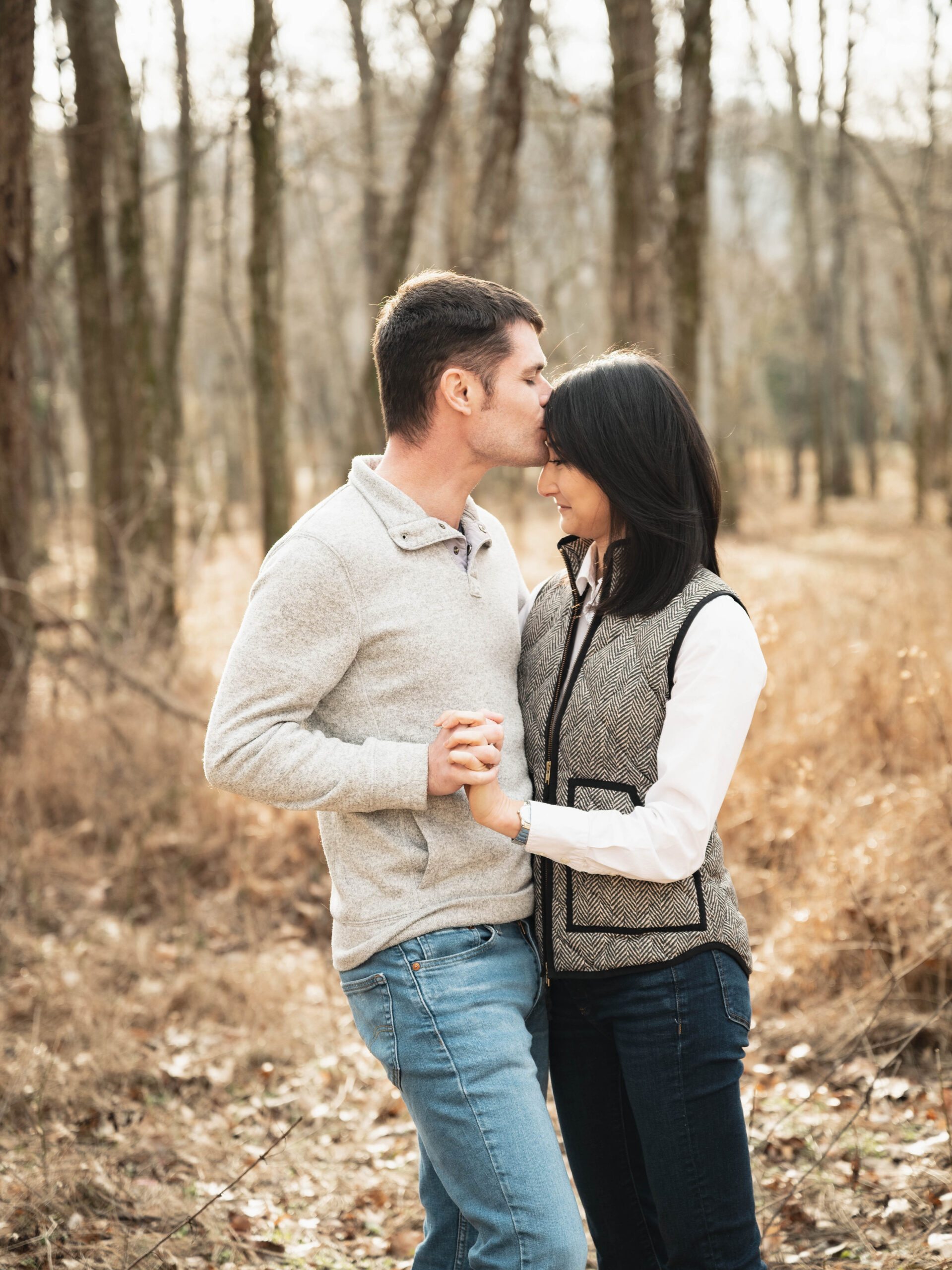 Wanting to stay warm, this couple wears sweaters and vests during their engagement session.