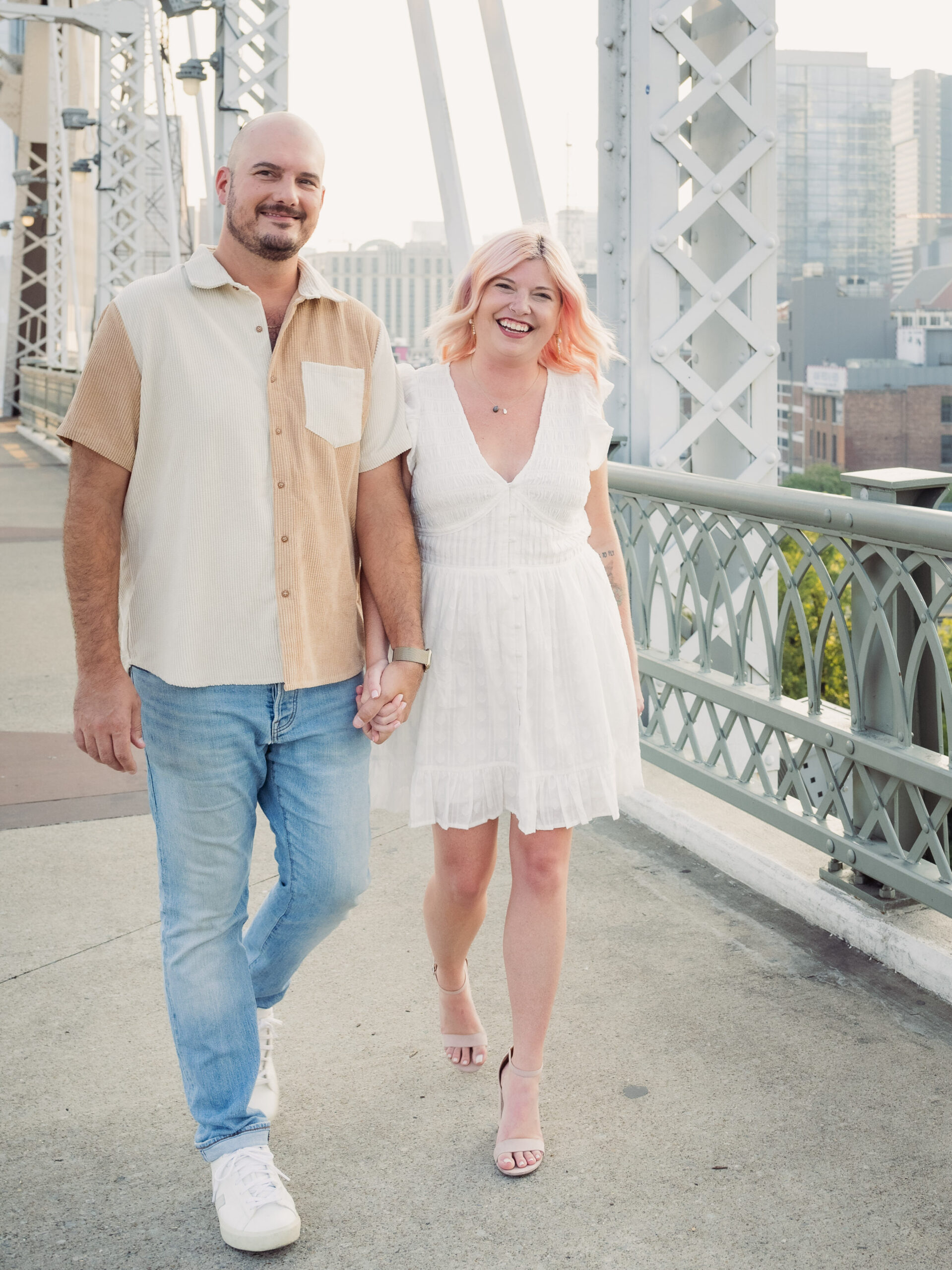 Couple wears light and airy colors for a brighter look in their engagement photo outfits.