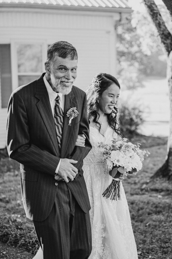 Quiet moments captured before walking down the aisle with her father helped to make a large wedding feel intimate.