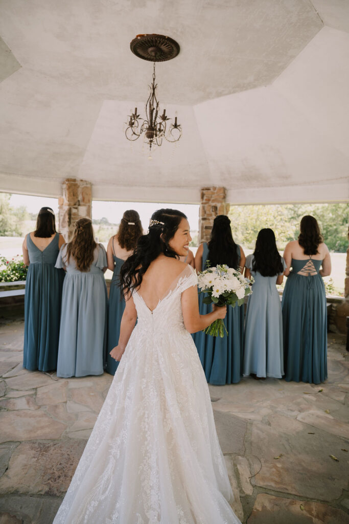 S looks over her shoulder just before the bridesmaids take their first look! A focus on celebrating connection helps to make a large wedding feel intimate.